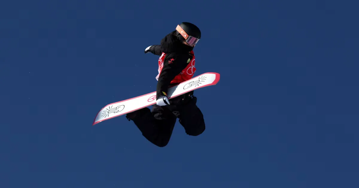 Snowboarder carving fresh powder lines layout view